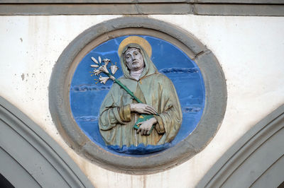 Low angle view of angel statue against building