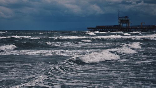 Scenic view of sea against cloudy sky