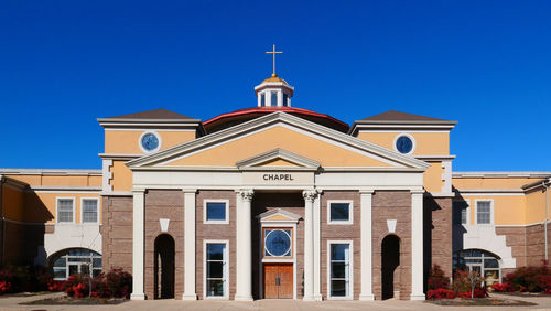 Low angle view of church against clear blue sky