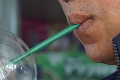 Close-up portrait of man drinking glass