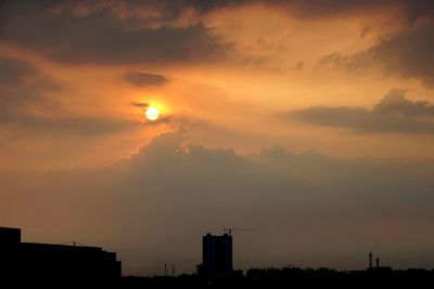 Silhouette of tree against dramatic sky