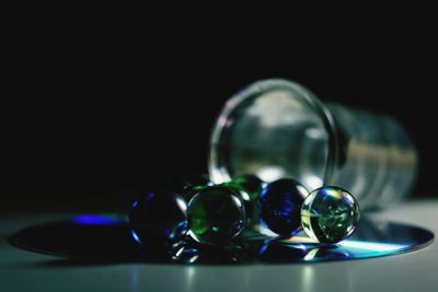 Close-up of colorful balls on table against black background