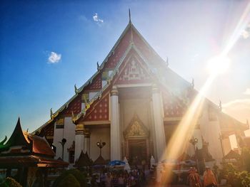 Group of people outside temple against building