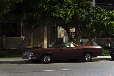 Car on street against buildings in city