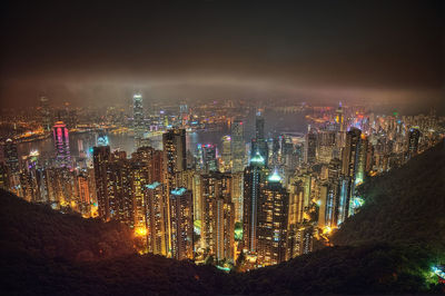 High angle view of illuminated cityscape against sky at night