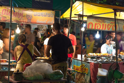 People at market stall in city