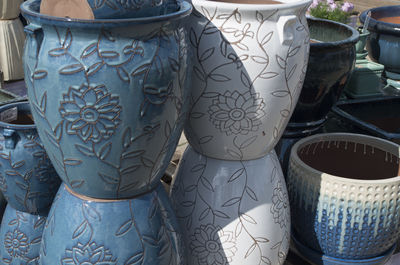 Decorative urns for sale at market stall on sunny day