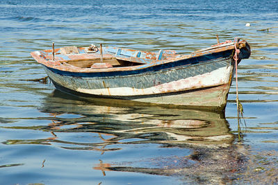 Abandoned boat moored at sea