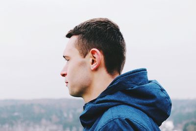 Side view of boy against clear sky