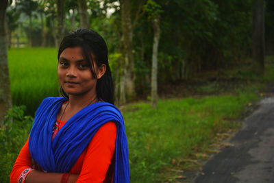 Portrait of beautiful woman standing on land