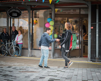 People standing at store in city