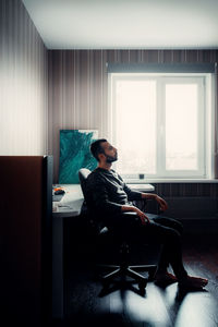 Man sitting on chair at table