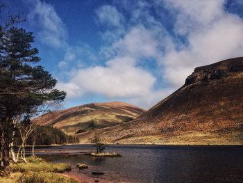 Scenic view of mountains against cloudy sky