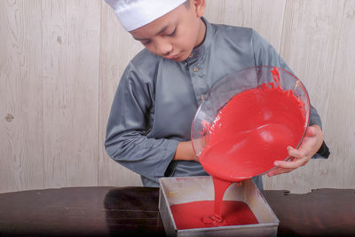 Boy preparing food on table at home