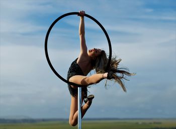 Full length of woman dancing on prop