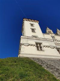 Low angle view of building against clear blue sky