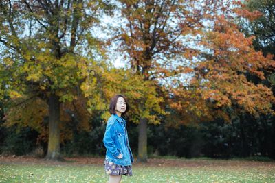 Woman standing in park during autumn