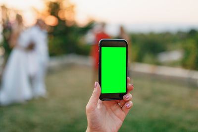 Close-up of hand holding mobile phone