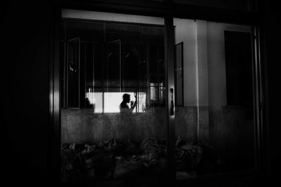 Man looking through window