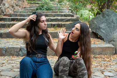 Young women sitting on steps at park