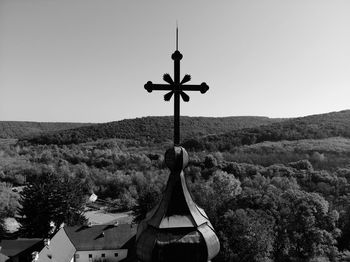 High section of church by landscape against clear sky