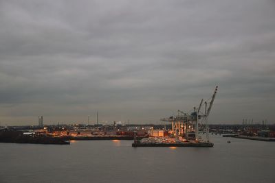 Commercial dock by sea against sky