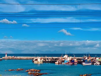 Sailboats in sea against sky