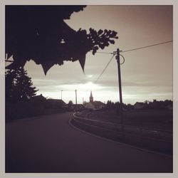 Road against cloudy sky at sunset