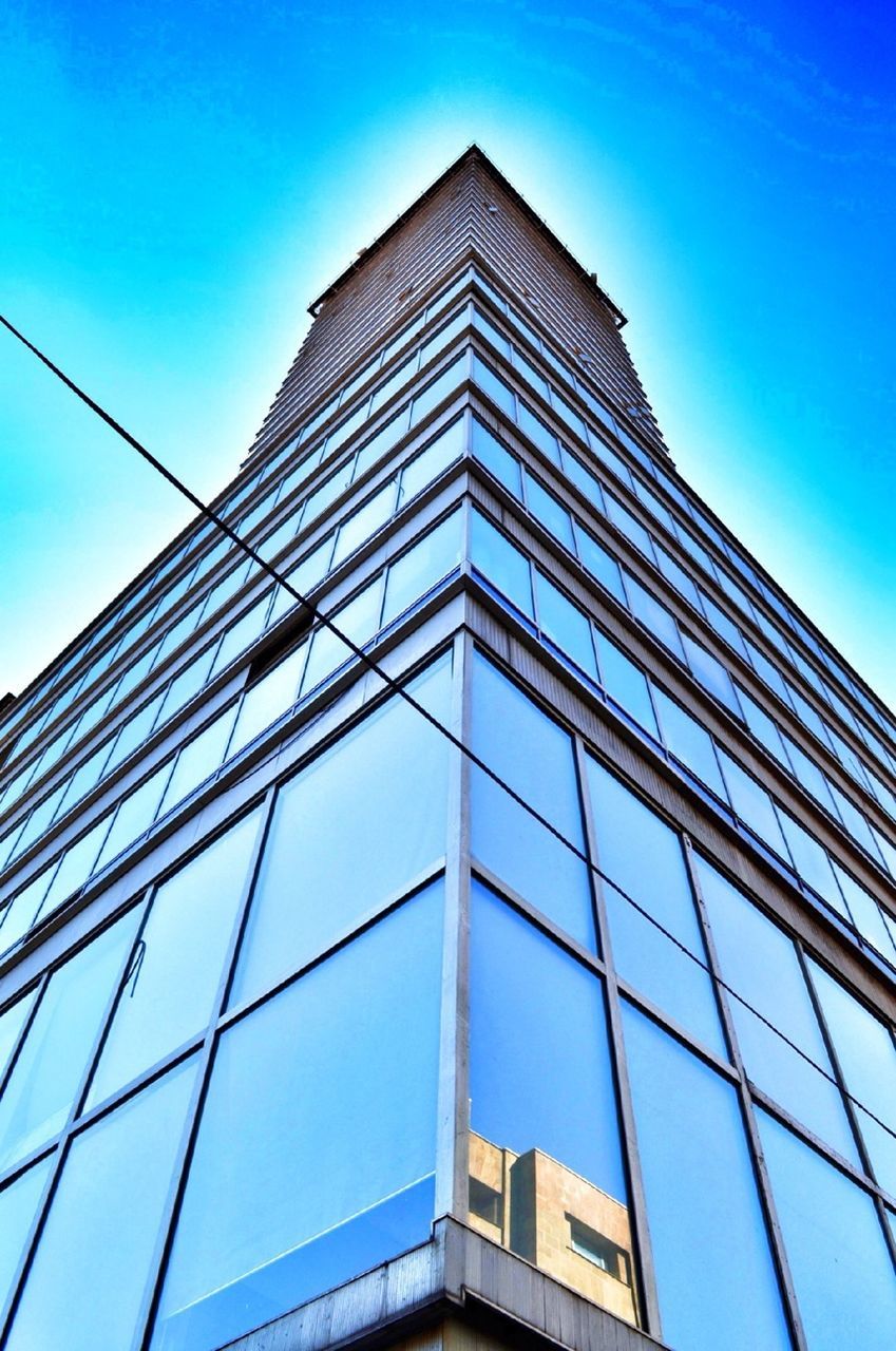 low angle view, architecture, building exterior, built structure, modern, office building, blue, tall - high, skyscraper, city, clear sky, tower, reflection, glass - material, building, sky, window, day, outdoors, no people