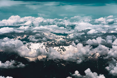 Aerial view of cloudscape over snowcapped mountains