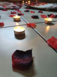 High angle view of lit candles on table