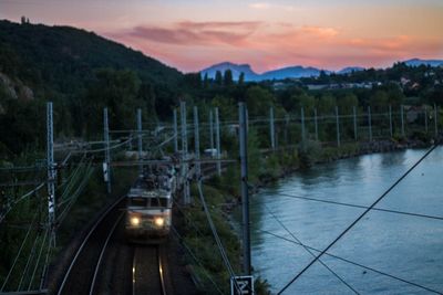 Bridge over river against cloudy sky