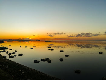 Scenic view of lake against sky during sunset