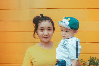 Portrait of cute boy against wall