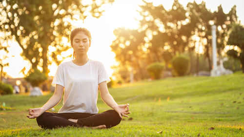 Portrait of young woman exercising in park