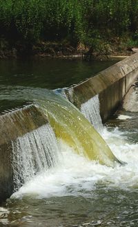 Scenic view of waterfall by river