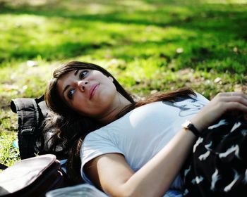 Portrait of young woman sitting on grass