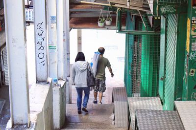 Rear view of people walking in city