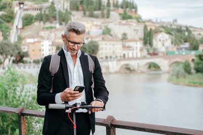Full length of man using mobile phone