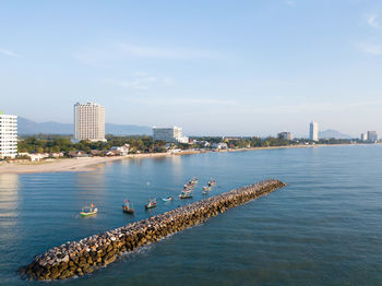 Scenic view of sea and buildings against sky