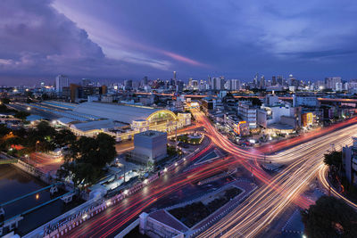 High angle view of illuminated cityscape against sky at night