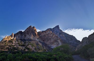 Scenic view of mountains against clear blue sky