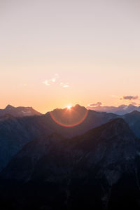 Scenic view of mountains against clear sky during sunset