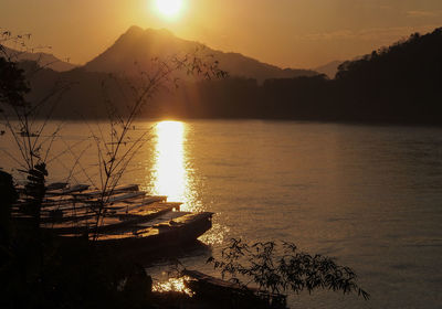 Scenic view of lake against sky during sunset