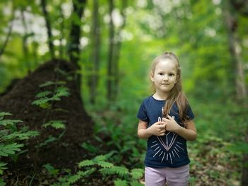 Full length of girl standing in forest