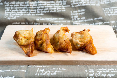 Close-up of fried dumplings on cutting board