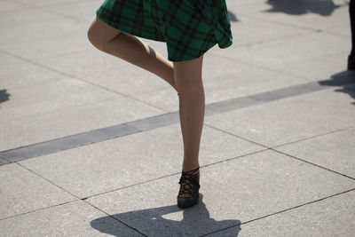 Low section of woman walking on tiled floor