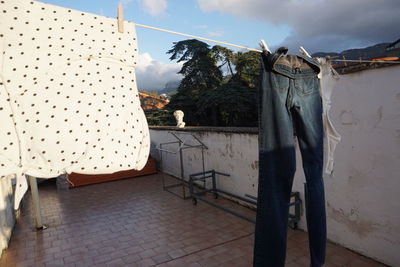 Clothes drying on clothesline against sky