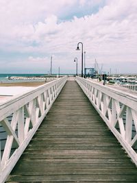 Pier over sea against sky