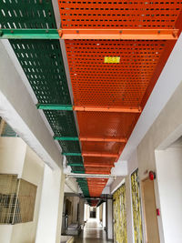 Low angle view of illuminated corridor of building